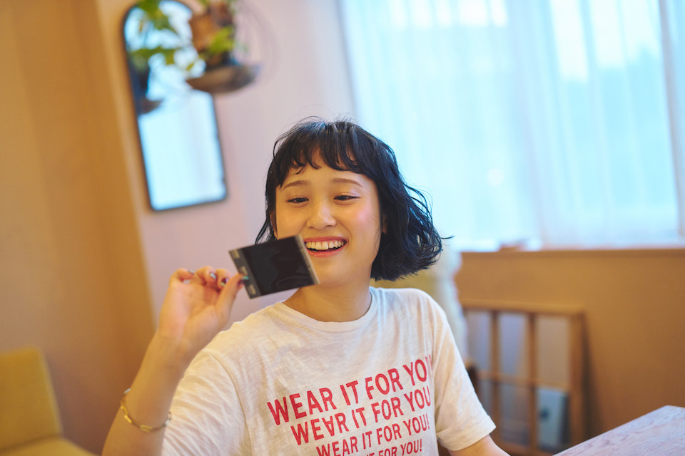 チェキプリントを見ているなちさんの写真